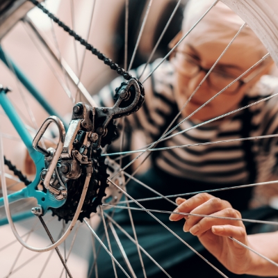 a woman fixes a bike